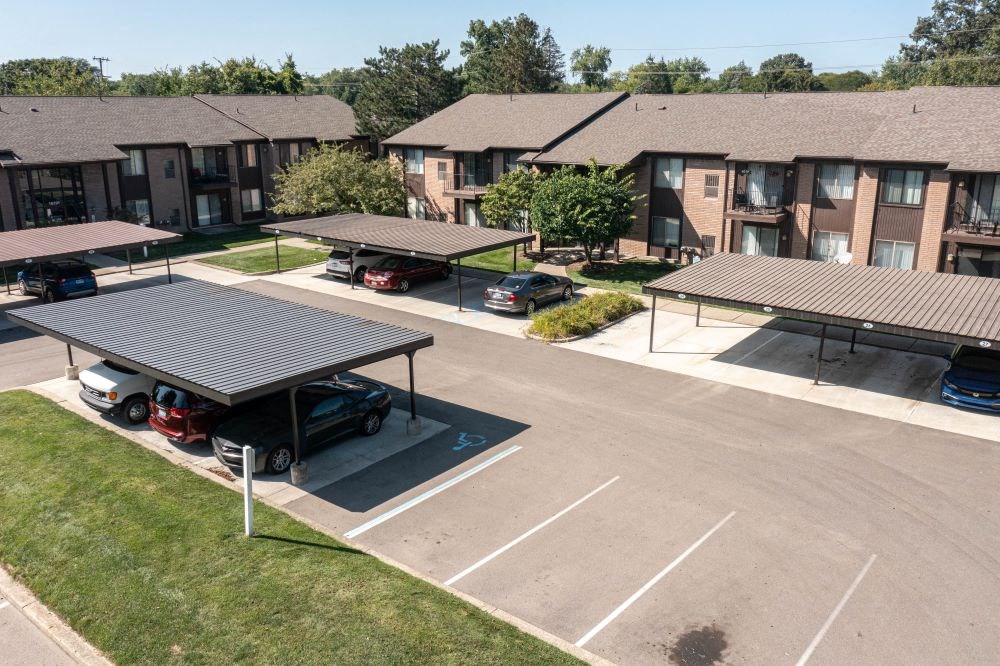 a parking lot in front of an apartment complex