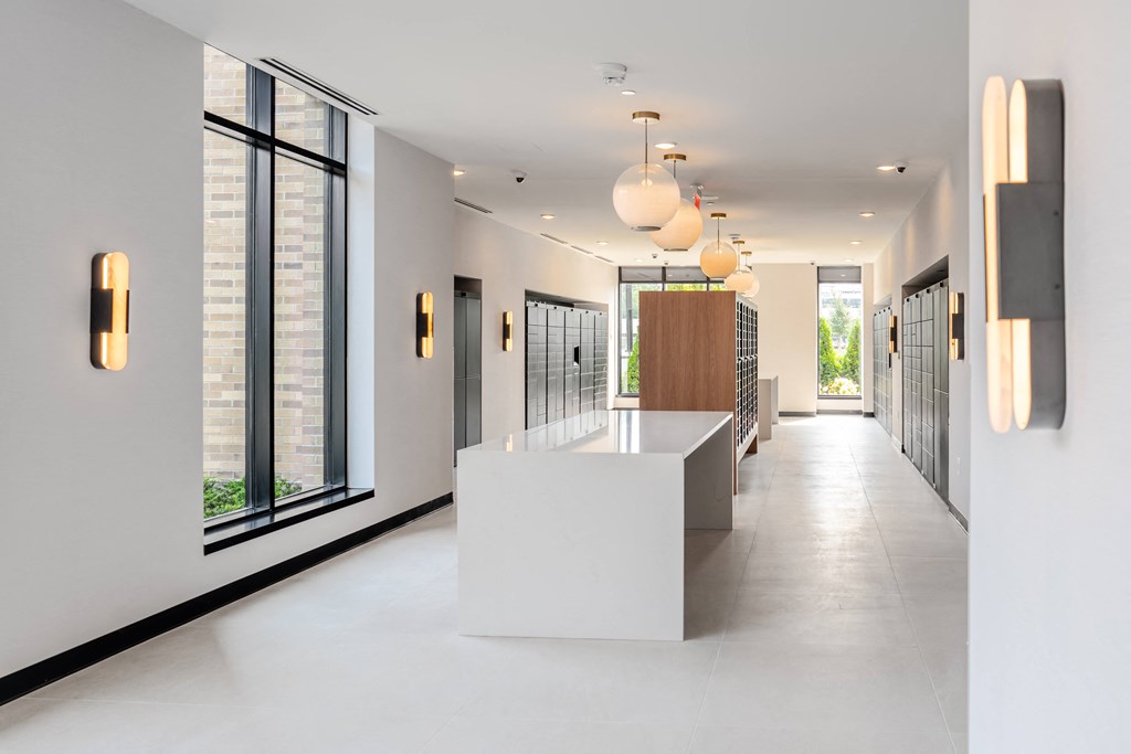 a long white reception desk in a lobby with large windows