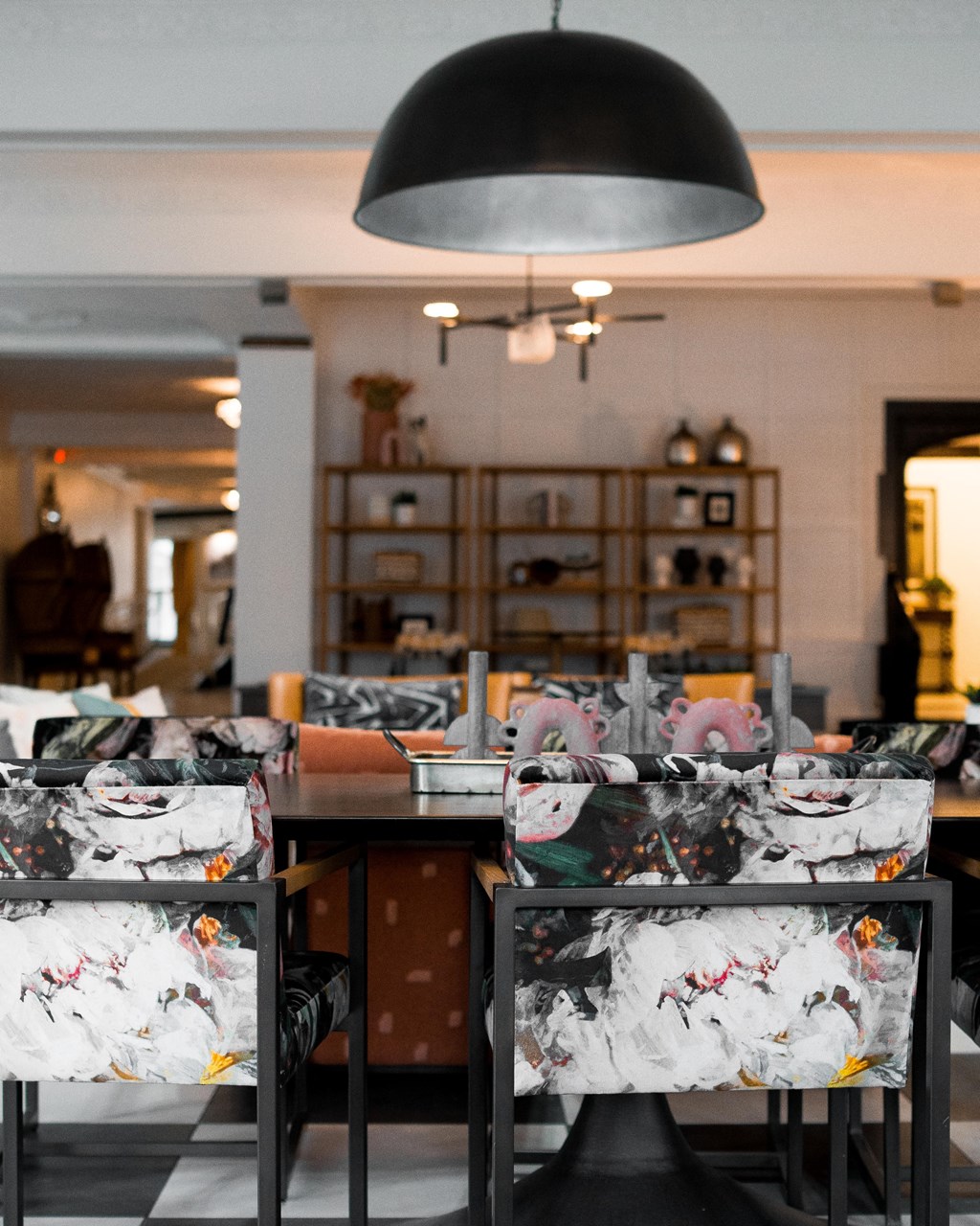 a dining room filled with chairs and a table with masks on it