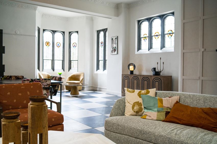 a living room with white walls and a checkered floor