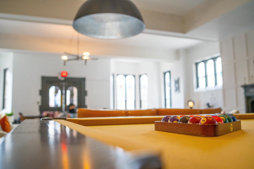 a large room with a table with a tray of colored balls on it