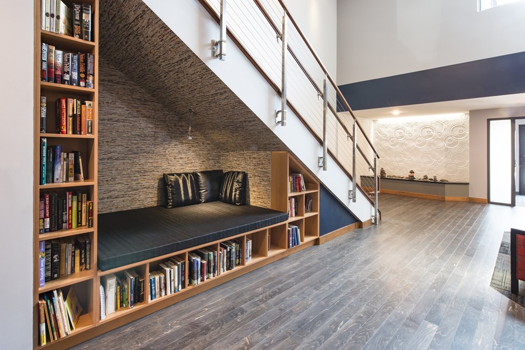 A staircase with a bookshelf on the side.