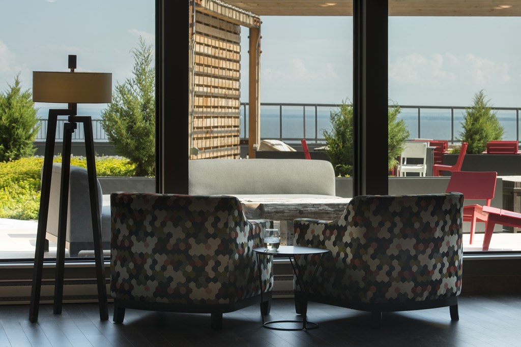 Two chairs are in front of a window with a view of the outside.