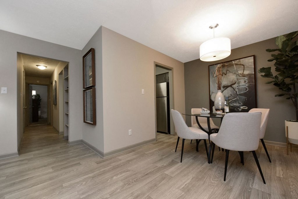 a dining room with a table and chairs and a hallway