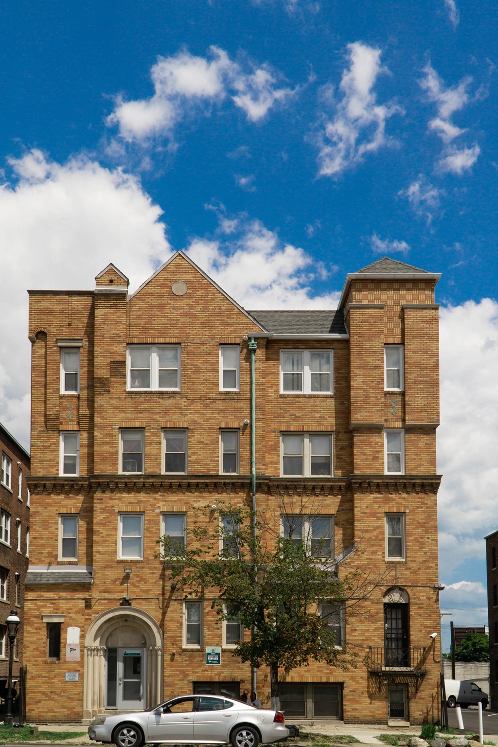 a brick building with a car parked in front of it