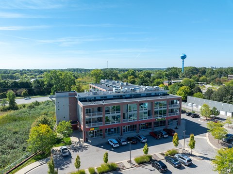 an aerial view of a building with cars parked in front of it