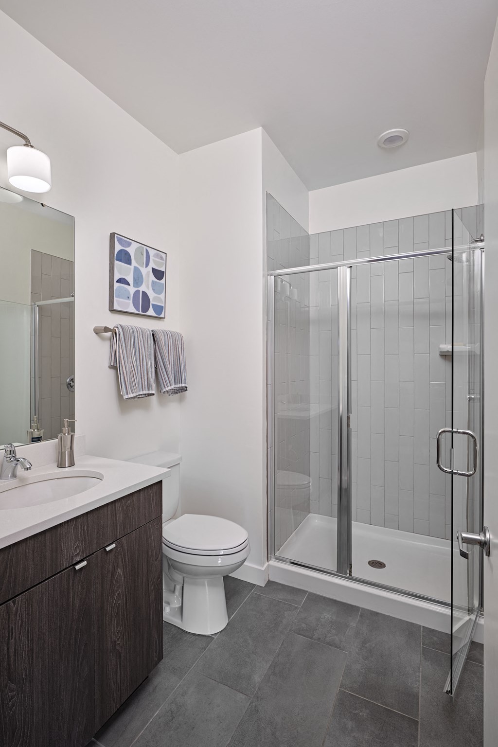 a bathroom with a shower and a sink and a toilet