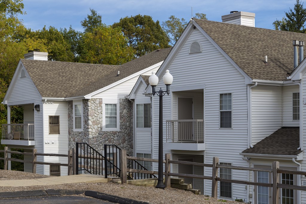 A white house with a black gate in front.