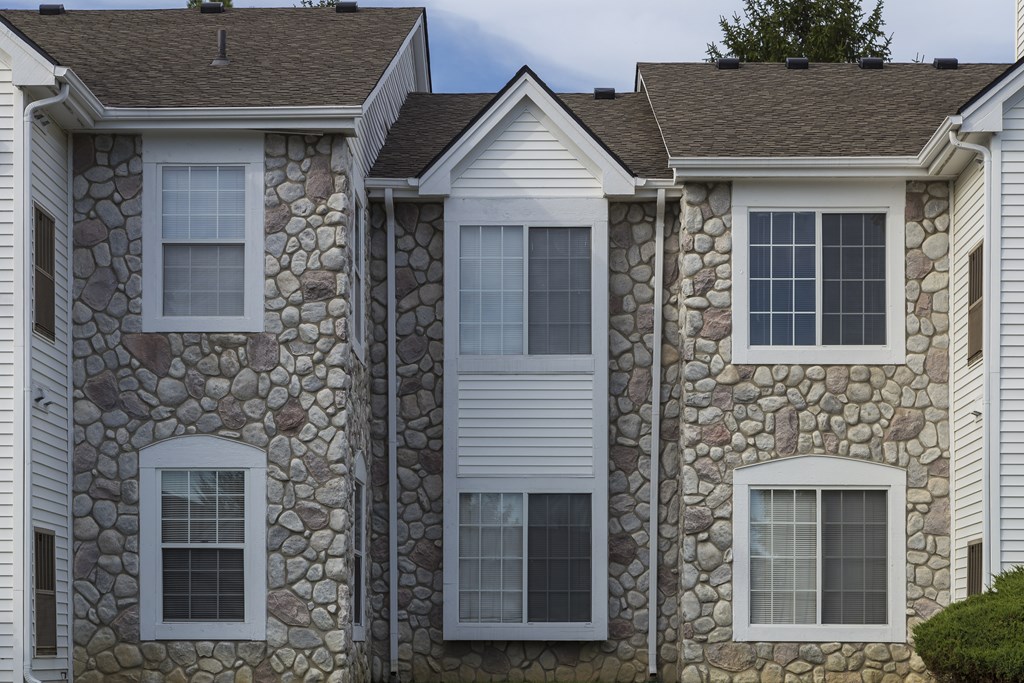 A row of houses with stone and siding exteriors.