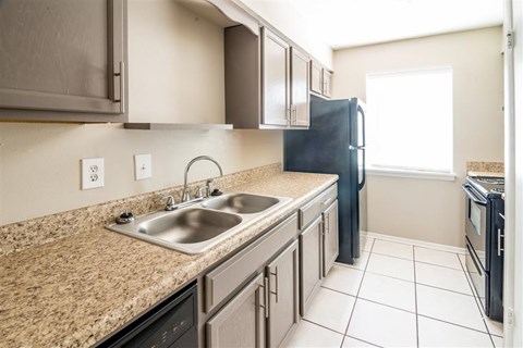a kitchen with a sink and a refrigerator