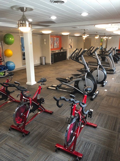 a room full of bikes and weights in a gym