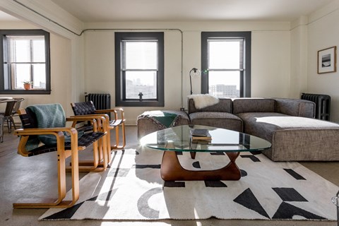 a living room with a couch and a glass coffee table