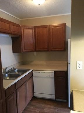 Kitchen with white appliances and laminate cabinets