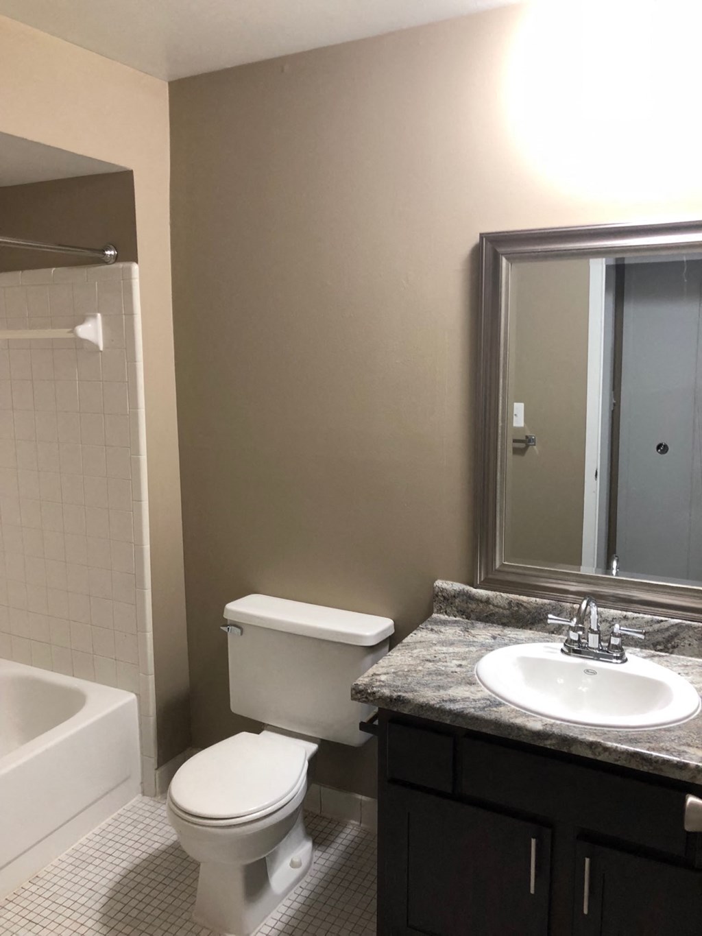a bathroom with a toilet and a sink and a shower