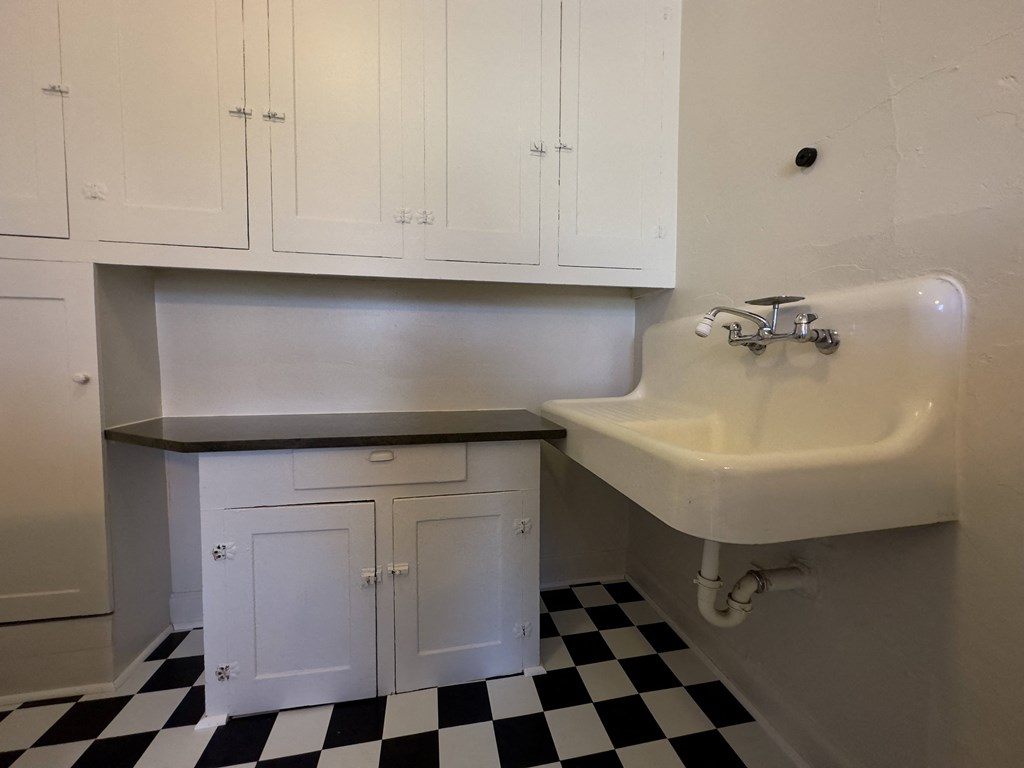 a small bathroom with a sink and a small cabinet