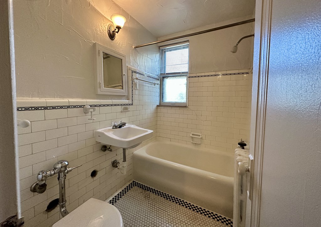 a bathroom with a sink toilet and bathtub