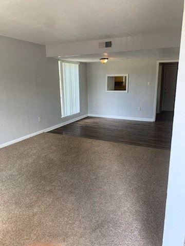 Living room leading to hallway with plush carpeting