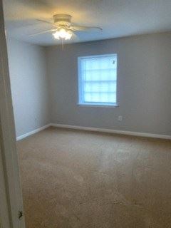 Bedroom with plush carpeting and ceiling fan