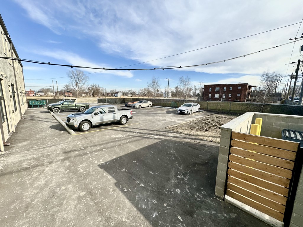 Gated empty parking lot with cars parked in it