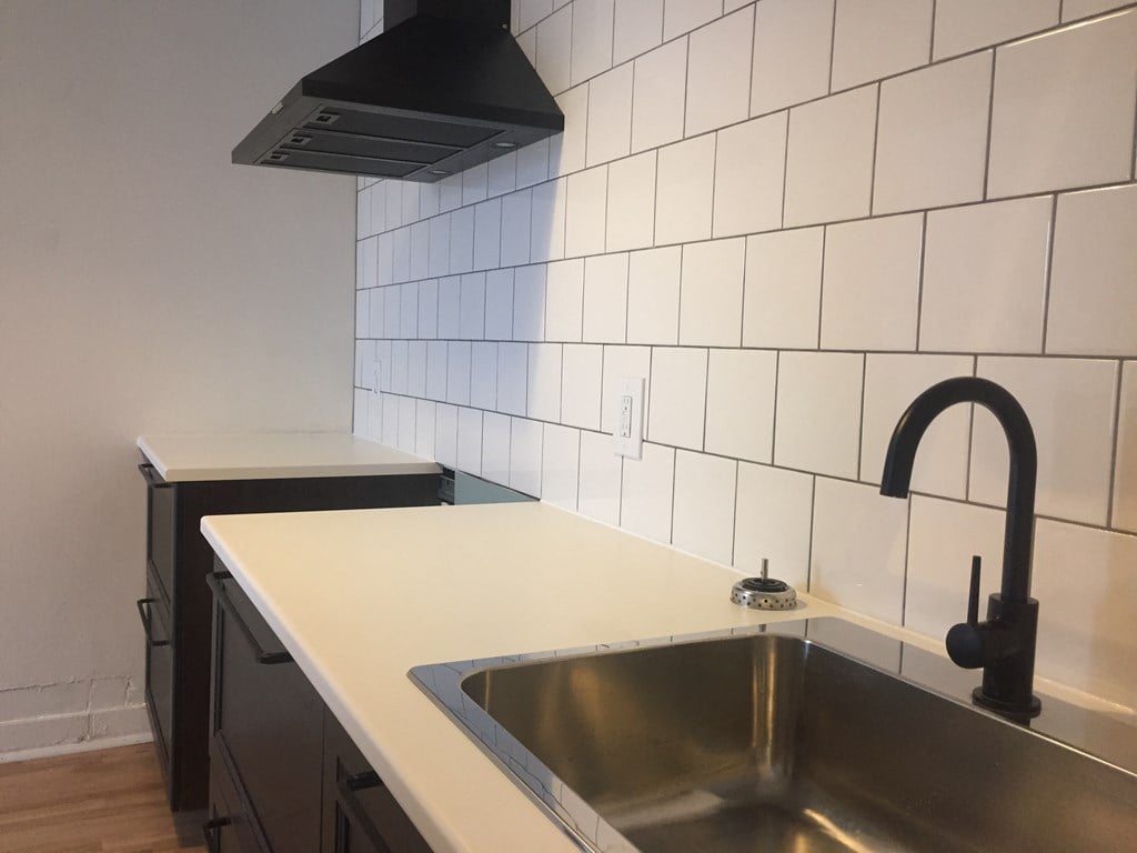 a kitchen with white countertops and black cabinets