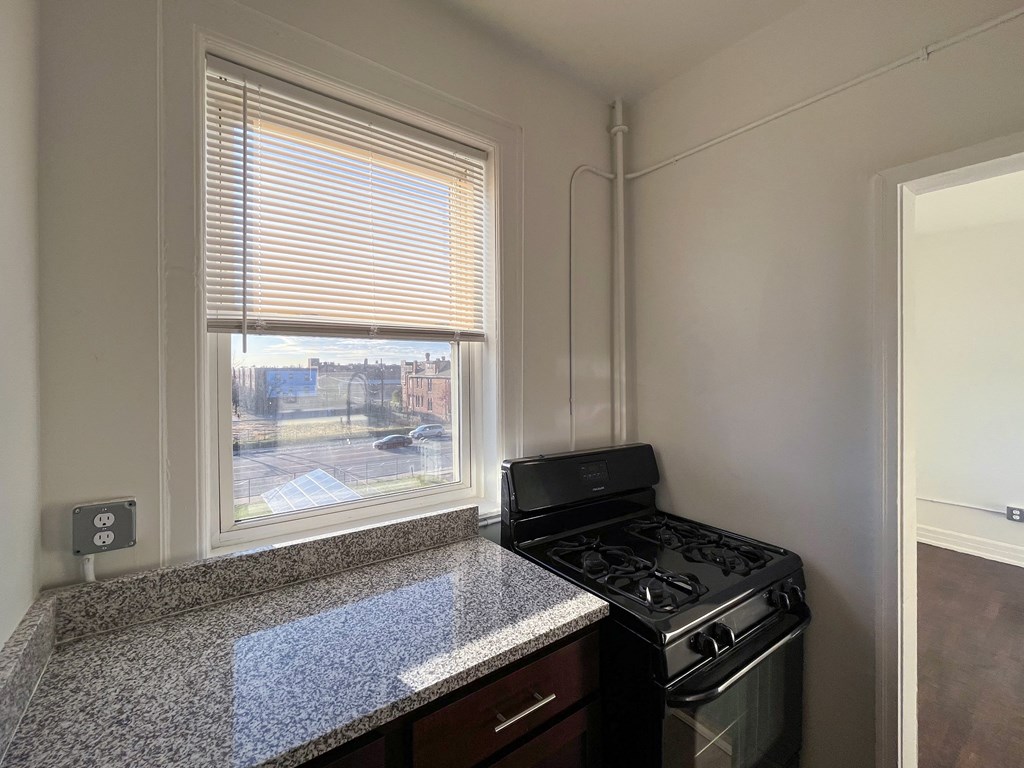 a kitchen with a stove and a window