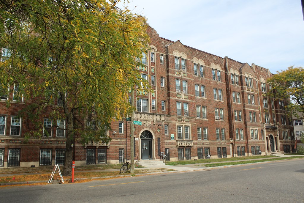 a large brick building on the corner of a street