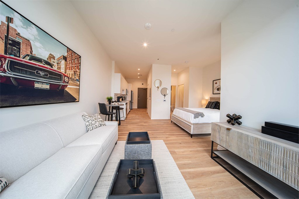 a living room with a white couch and a tv