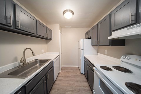 a kitchen with white appliances and black cabinets