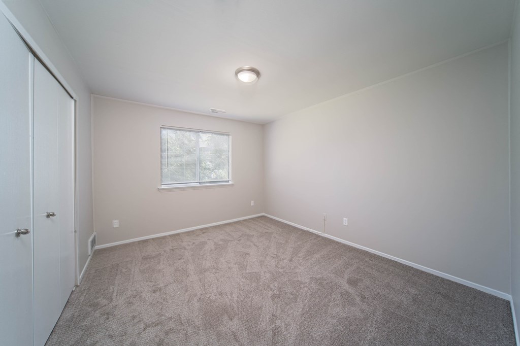 bedroom with white walls and window