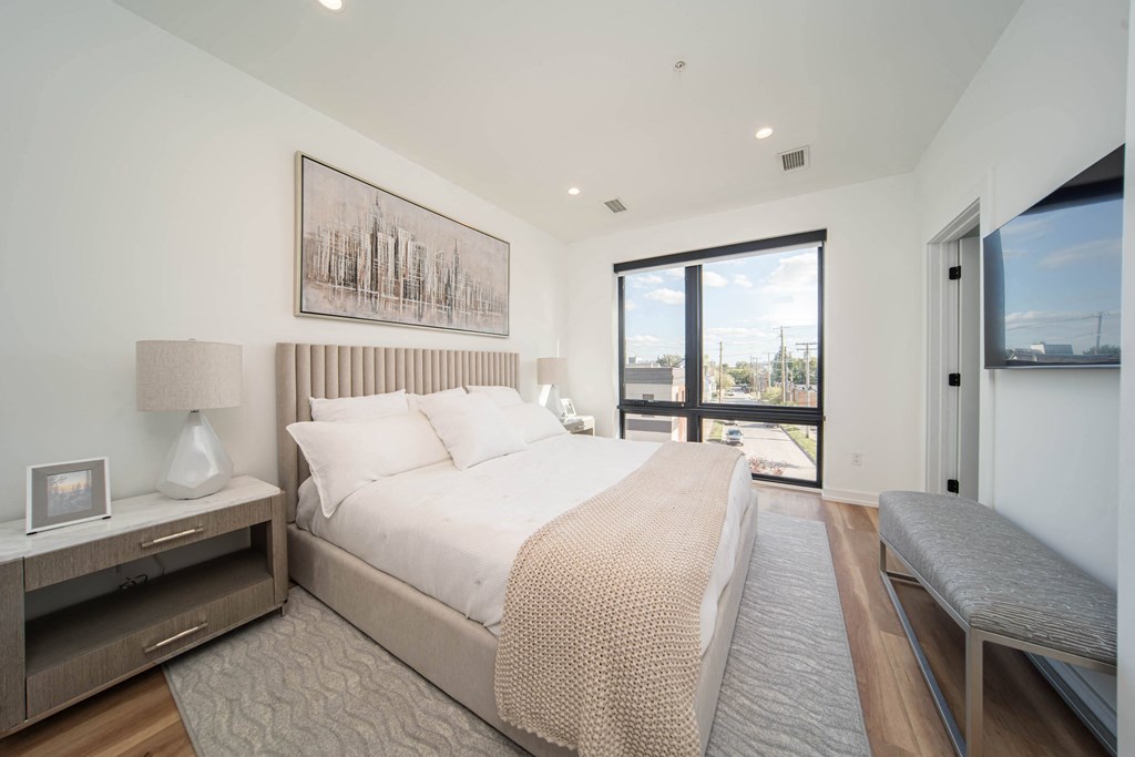 a bedroom with a large bed and a window