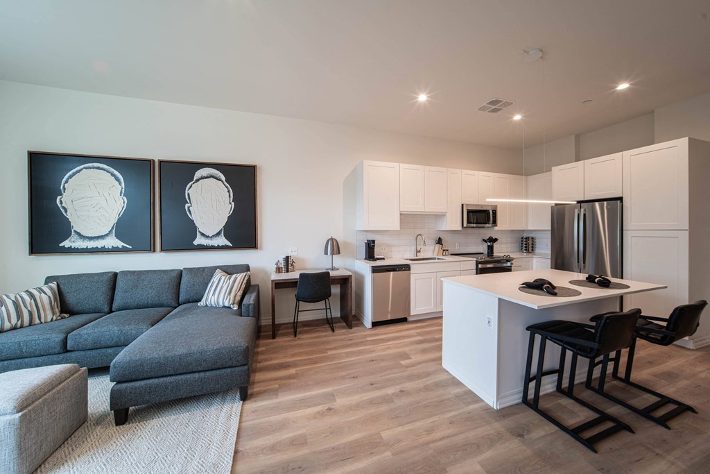 a living room with a kitchen and a couch and a table
