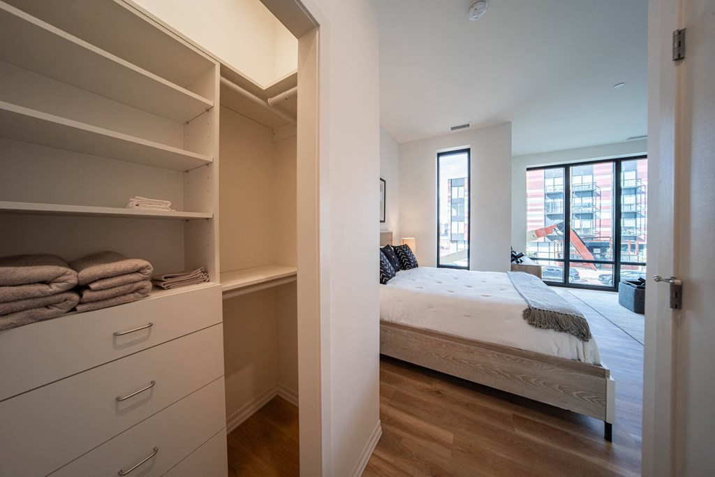 a bedroom with a bed and a closet