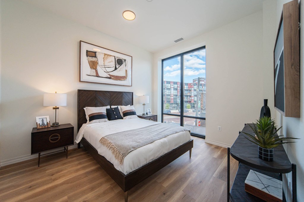 a bedroom with a large bed and a large window