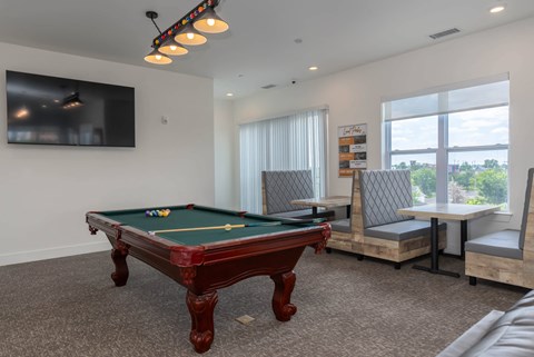 a games room with a pool table and a tv  at City View Apartments, Michigan