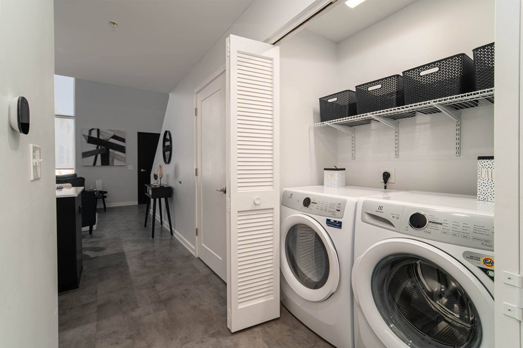 a washer and dryer in a laundry room with a closet