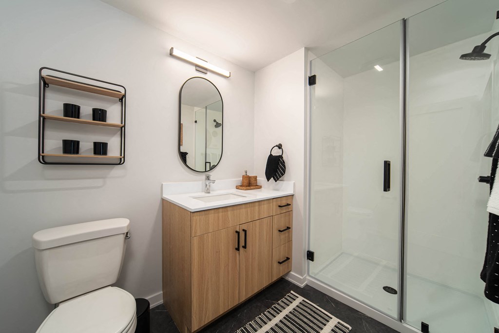 a bathroom with a toilet sink and shower