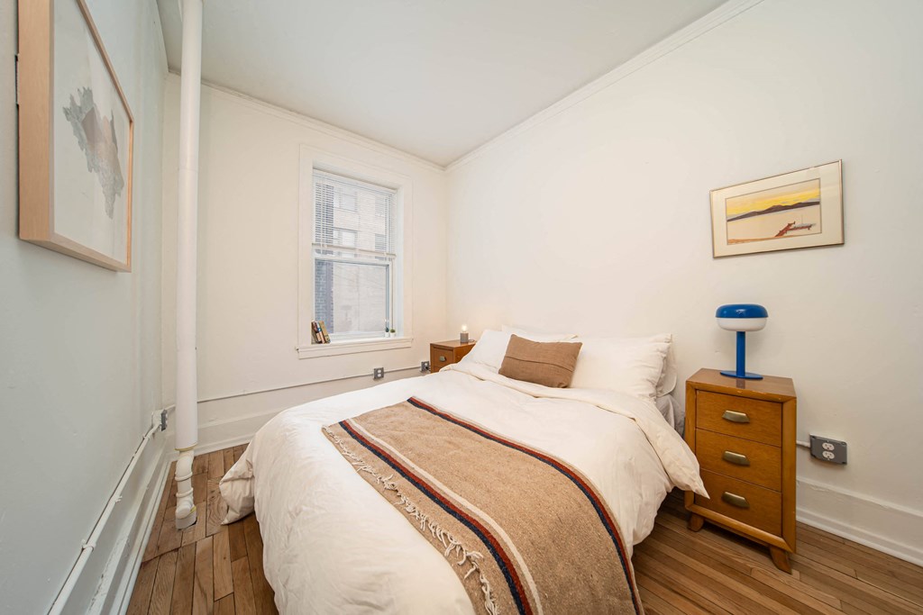 a bedroom with a bed and a window