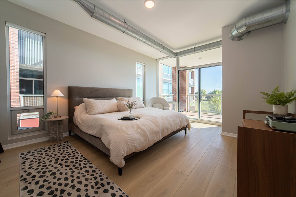 a bedroom with a large bed and a window