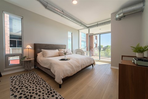 a bedroom with a large bed and a window
