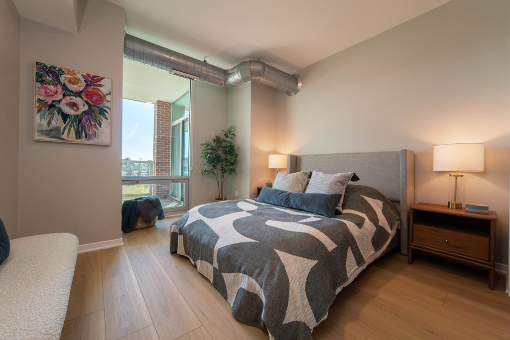 a bedroom with a bed and a large window
