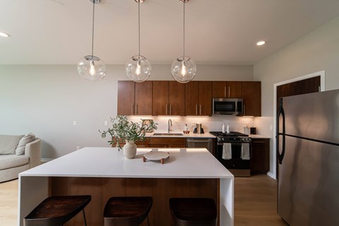 a kitchen with a white counter top and a refrigerator