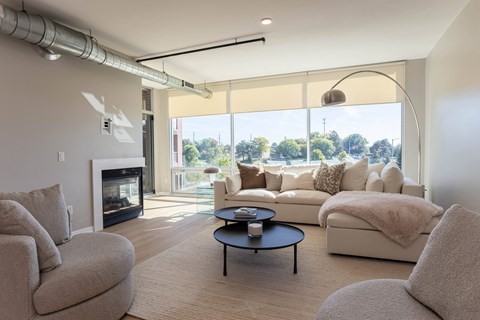 a living room with a couch and a chair and a fireplace