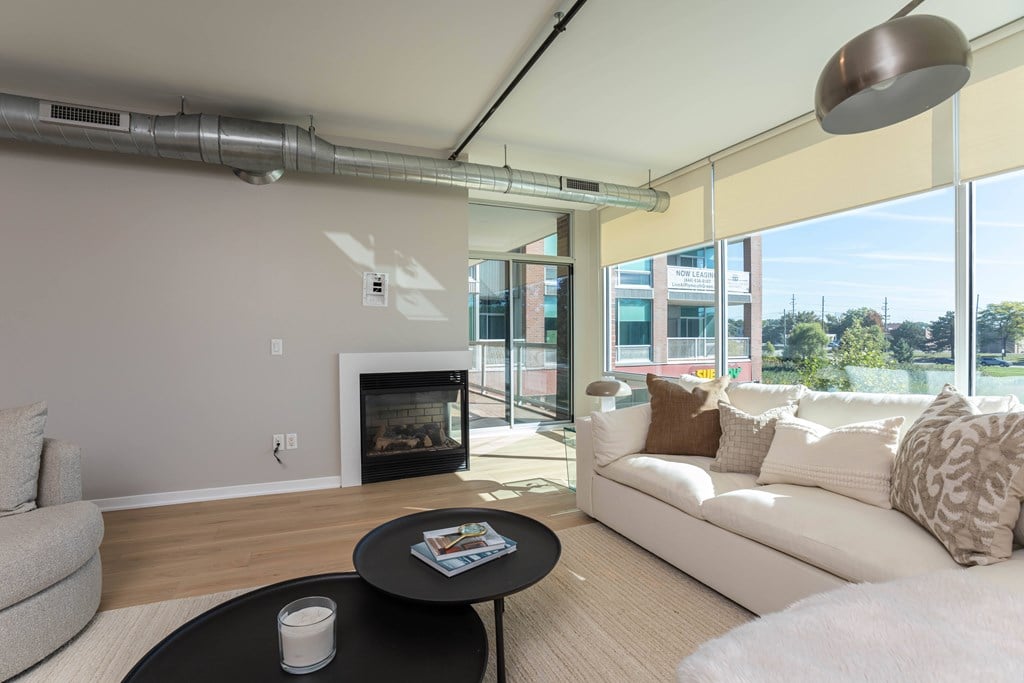 a living room with a couch and a coffee table and a fireplace