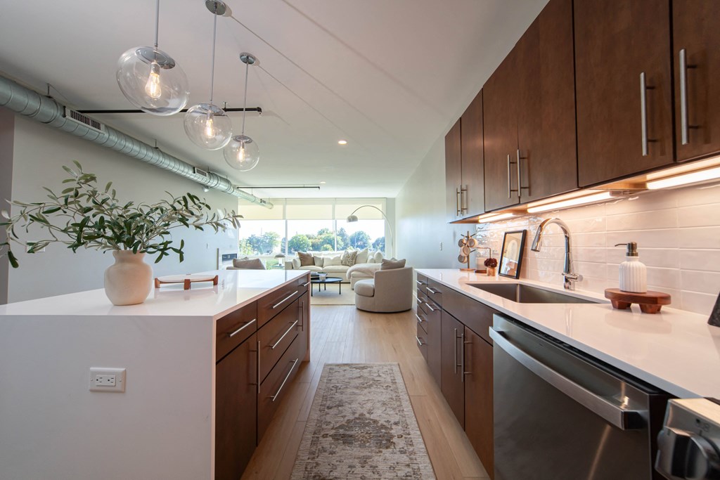 a kitchen and living room in a modern apartment
