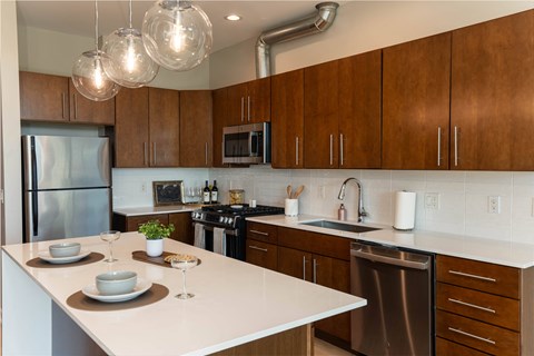 a kitchen with wooden cabinets and a white counter top