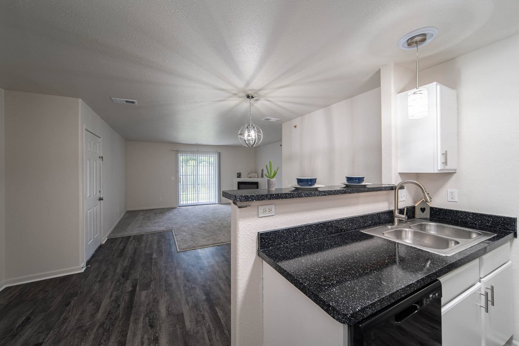 a kitchen with granite counter tops and a sink