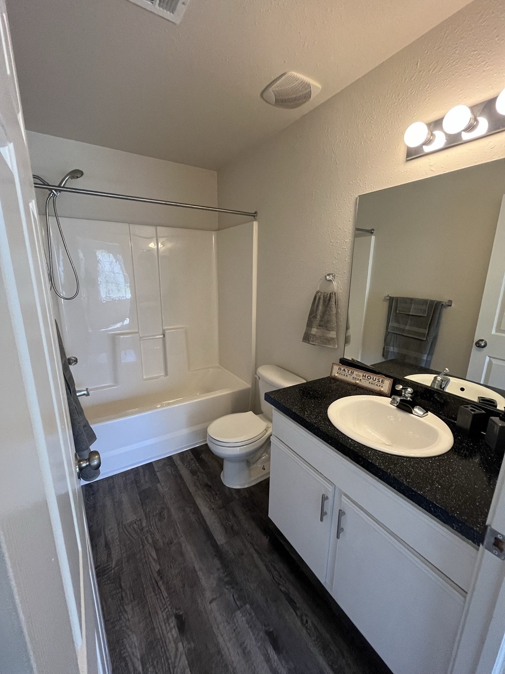 a bathroom with a sink and a toilet and a shower