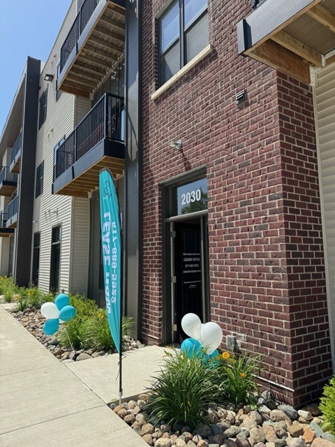 a brick building with balloons in front of it