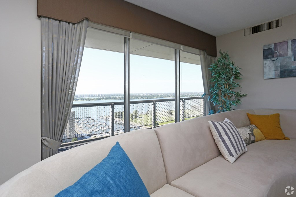 a living room with a white couch and a view of the city