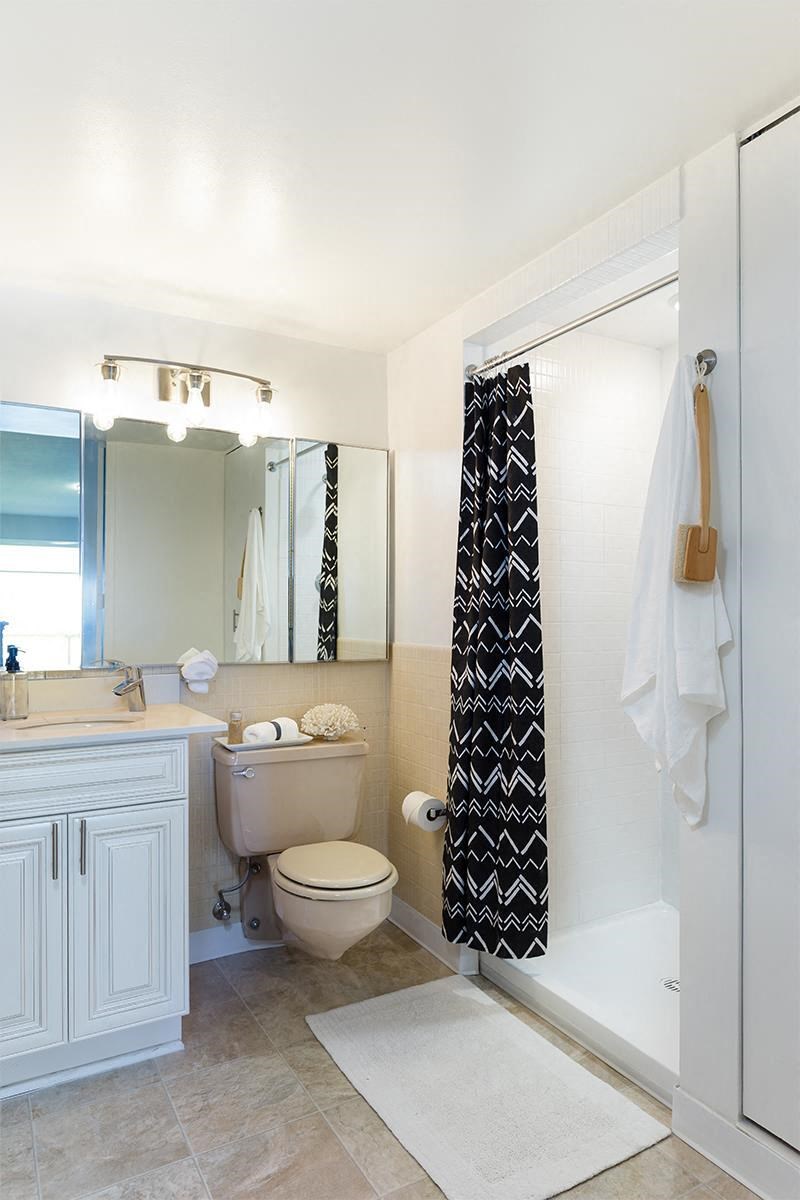 a bathroom with a toilet and a shower